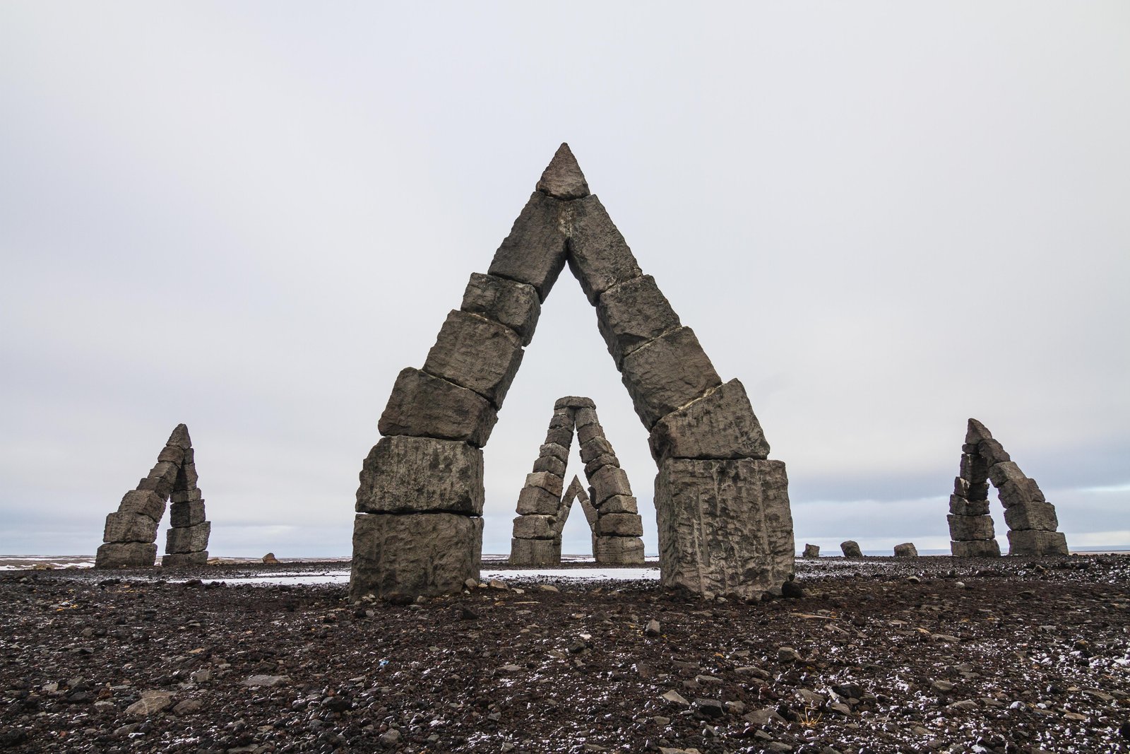arctic-henge-surrounded-by-field-covered-snow-cloudy-sky-iceland