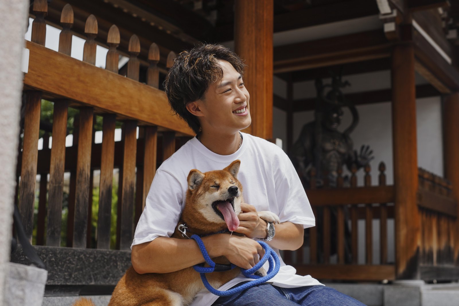 asian-man-with-his-shiba-inu-dog-outdoors