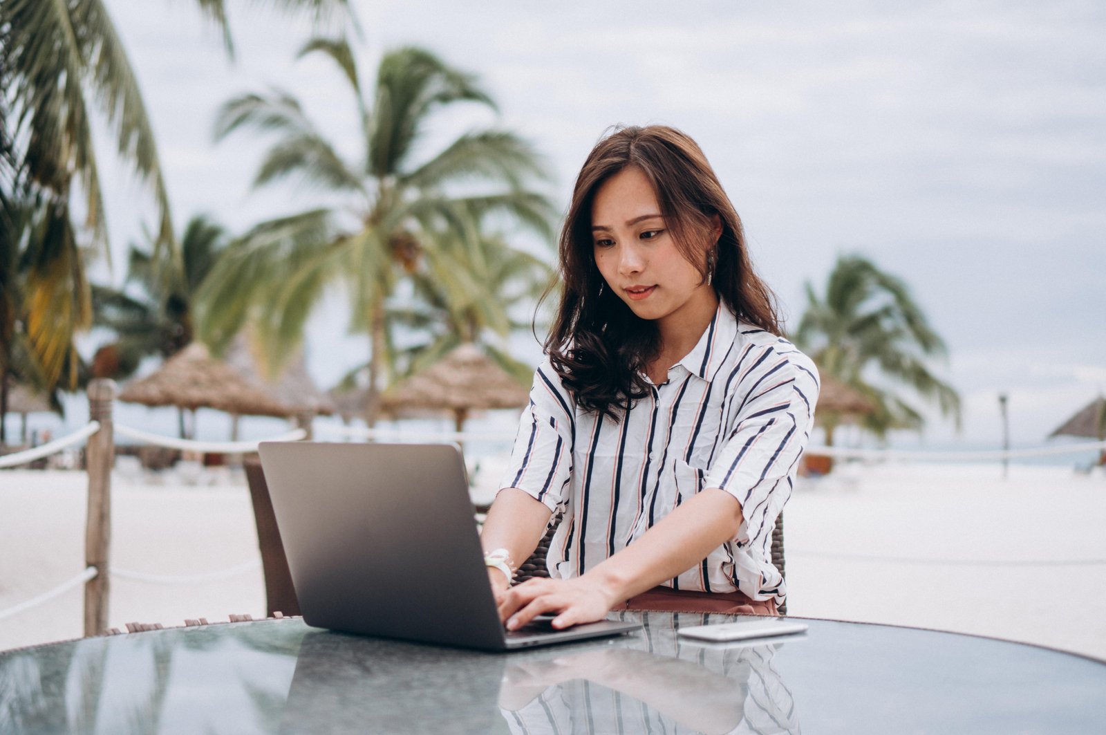asian-woman-working-laptop-vacation