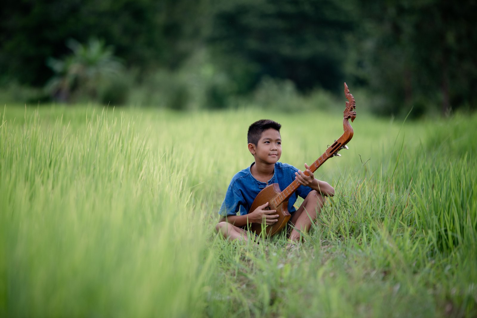 asian-young-boy-with-guitar-handmade-outdoor-life-country