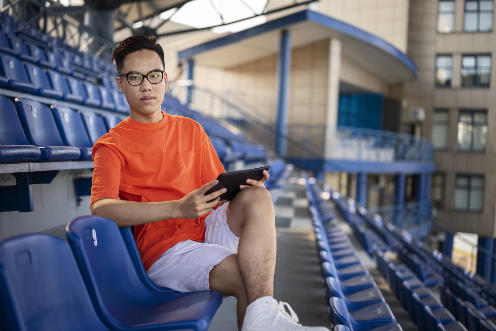 full-shot-man-sitting-with-tablet