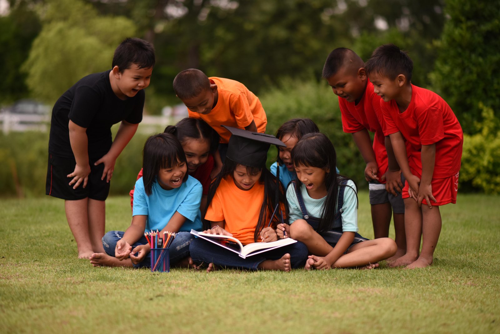 group-children-lying-reading-grass-field-2