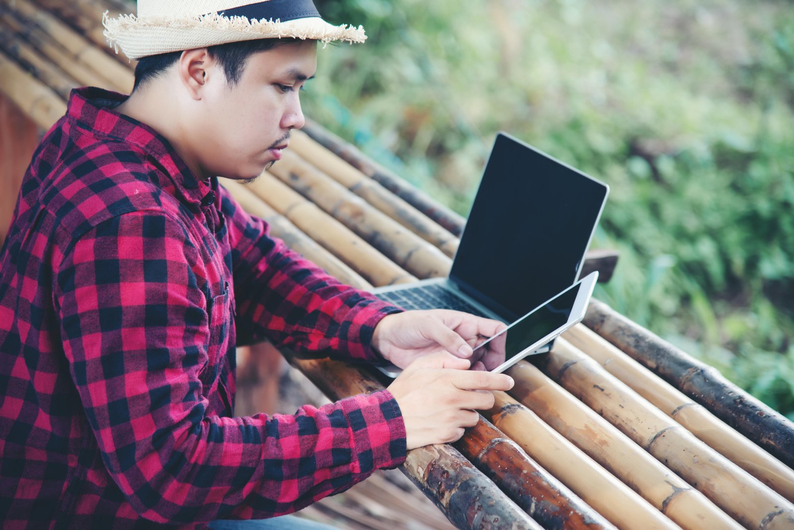 handsome-man-using-laptop-travel-nature