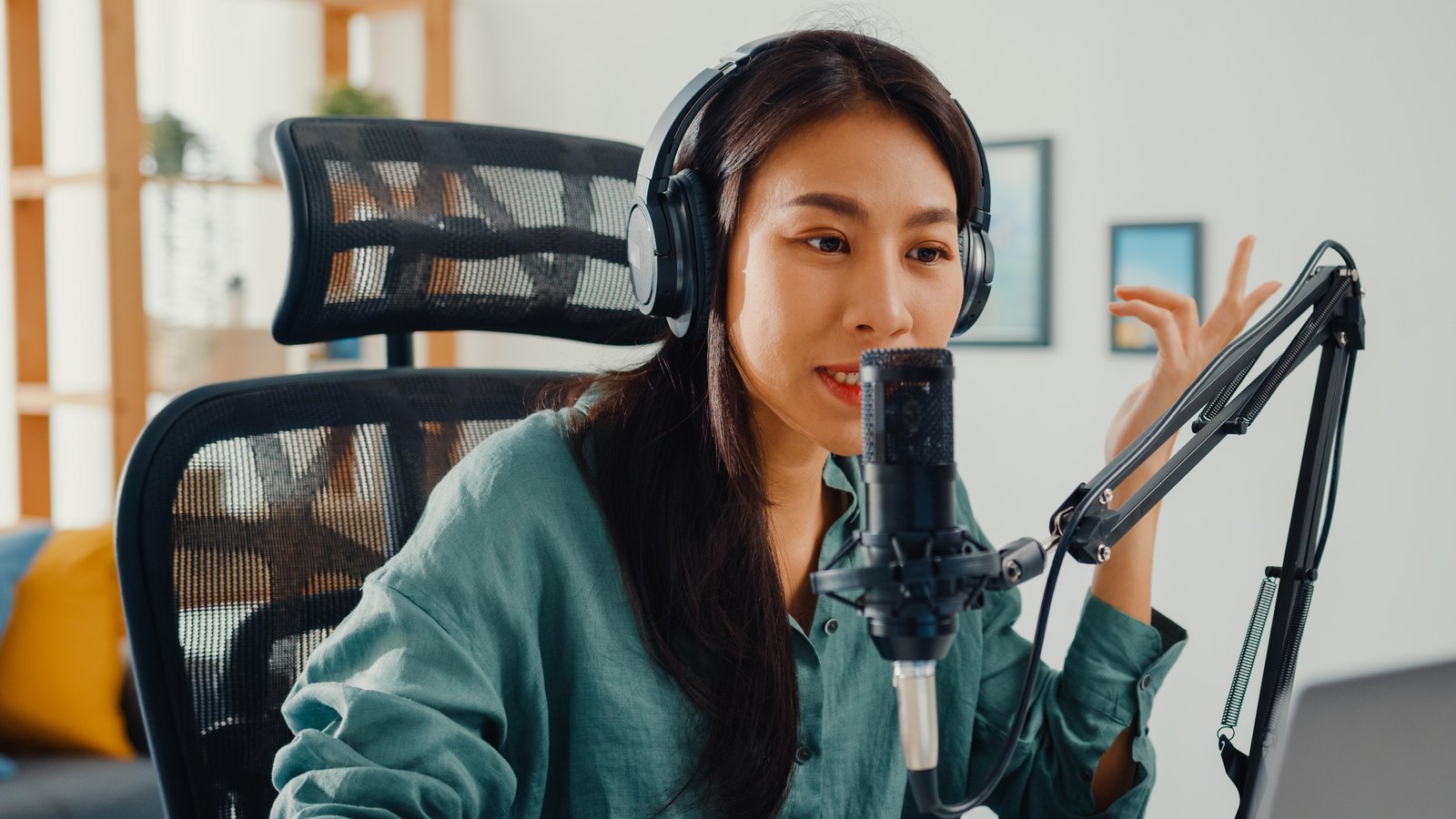 happy-asian-girl-recording-podcast-her-laptop-computer-with-headphones-microphone