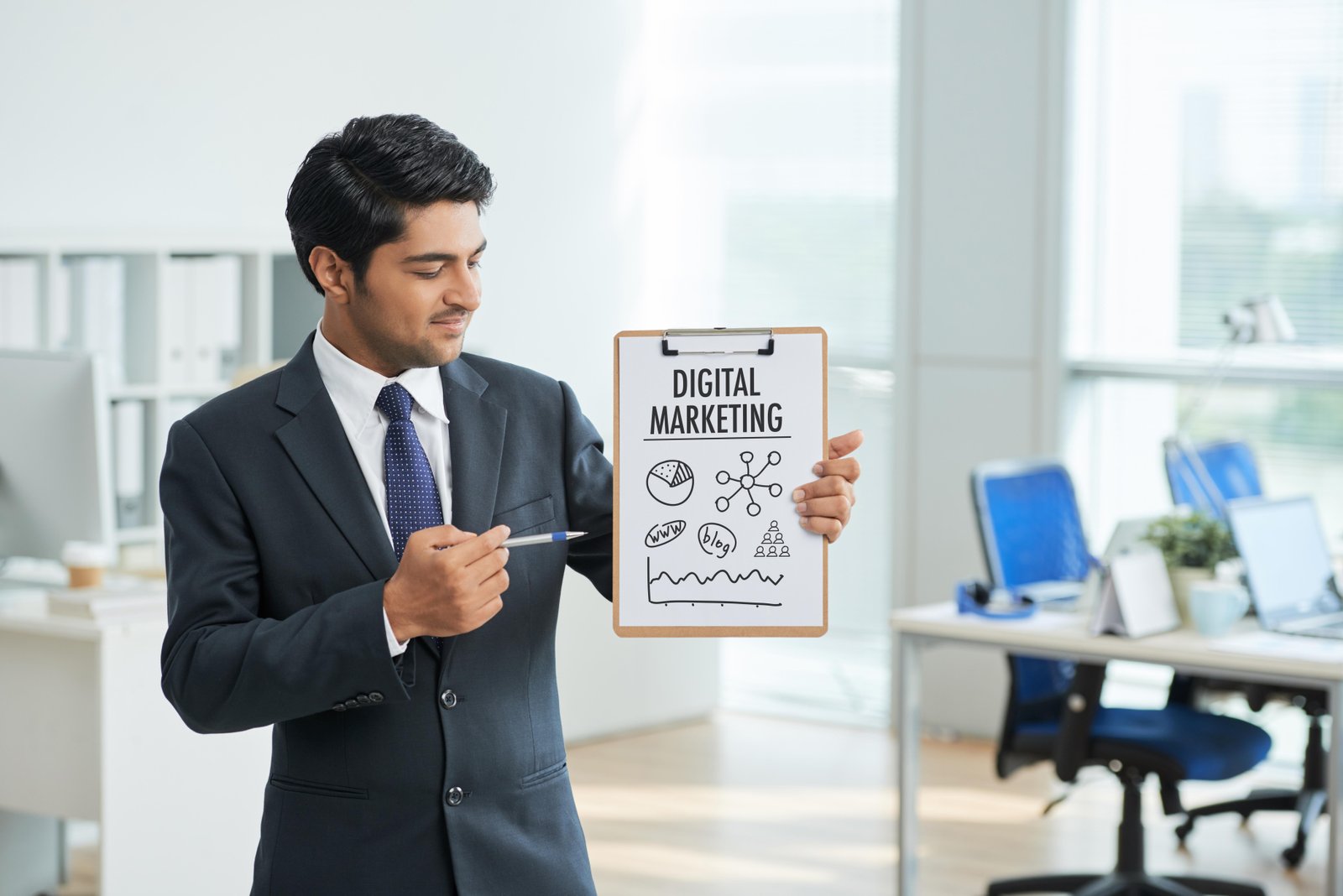 man-suit-standing-office-with-clipboard-pointing-poster-with-words-1