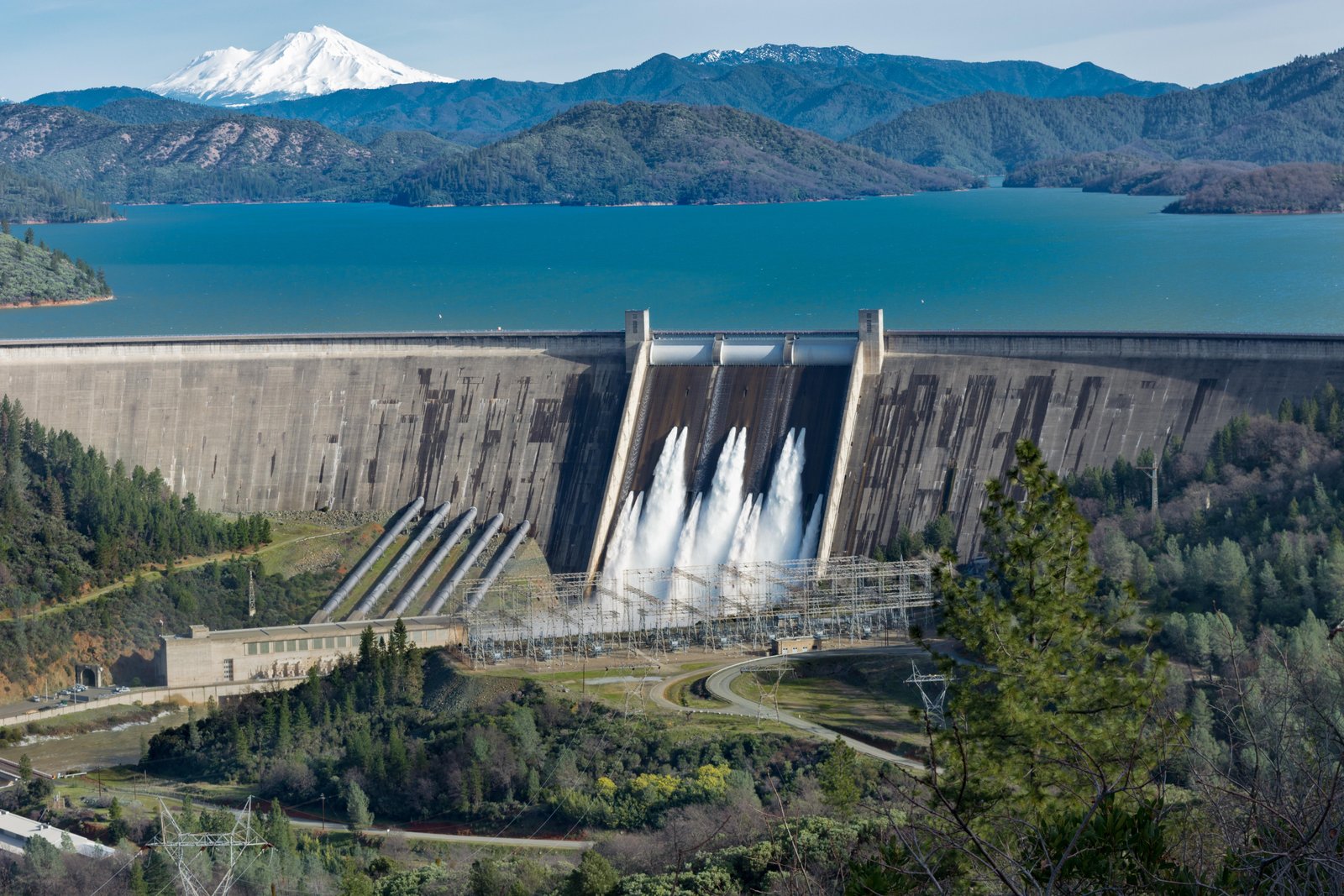 picture-shasta-dam-surrounded-by-roads-trees-with-lake-mountains