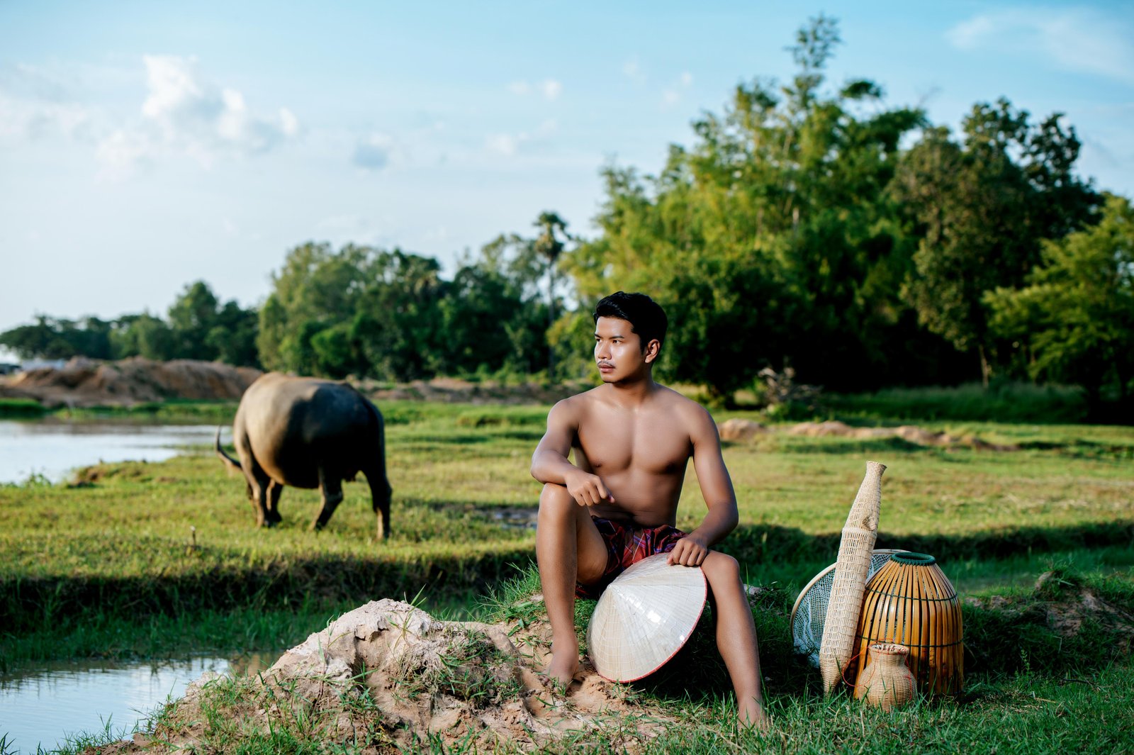 portrait-young-man-topless-wearing-loinclothes-rural-lifestyle-sitting-with-bamboo-fishing-trap