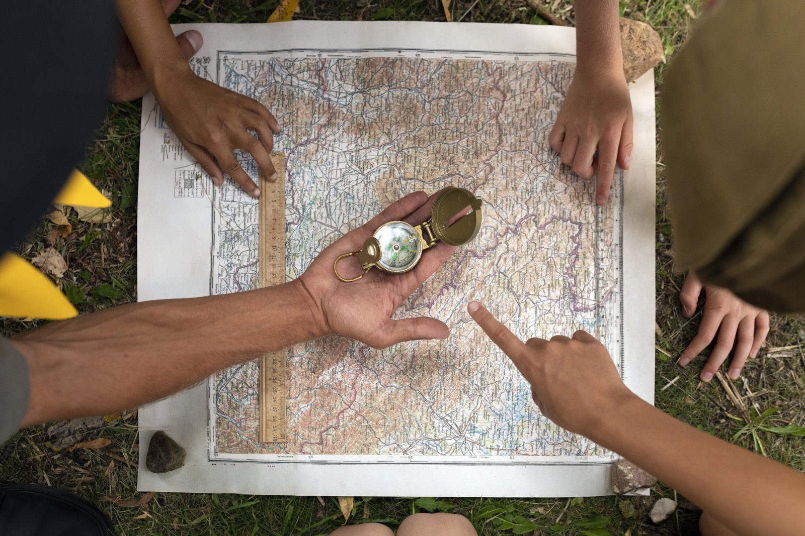 scouts-playing-with-map-top-view