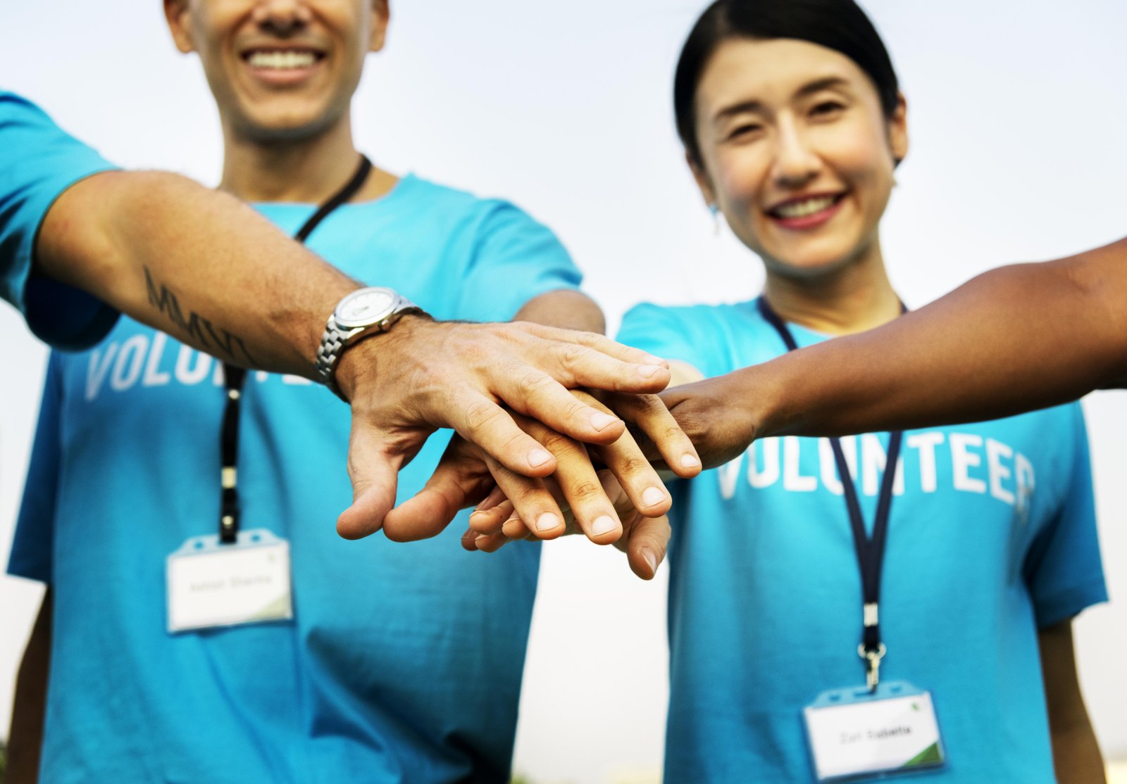 team-volunteers-stacking-hands