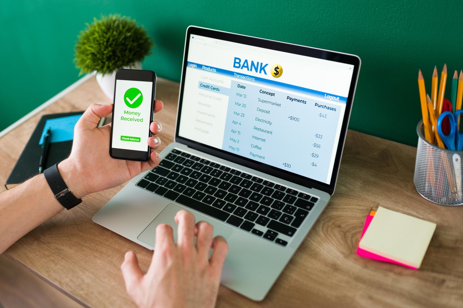 wire-transfer-young-man-using-his-smartphone-laptop-banking-transaction-some-payments