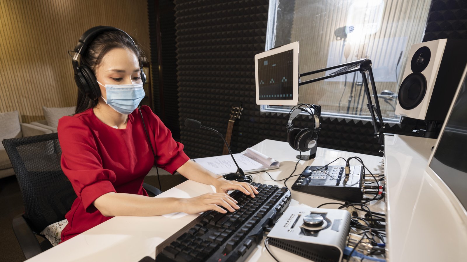 woman-with-face-mask-working-radio-with-professional-equipment